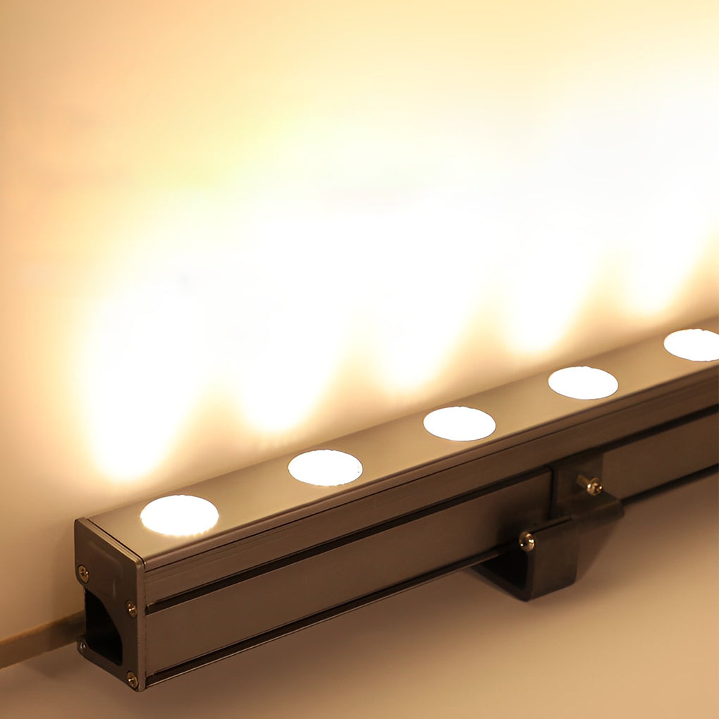 Linear LED wall washer light emitting uniform warm light against wall surface.