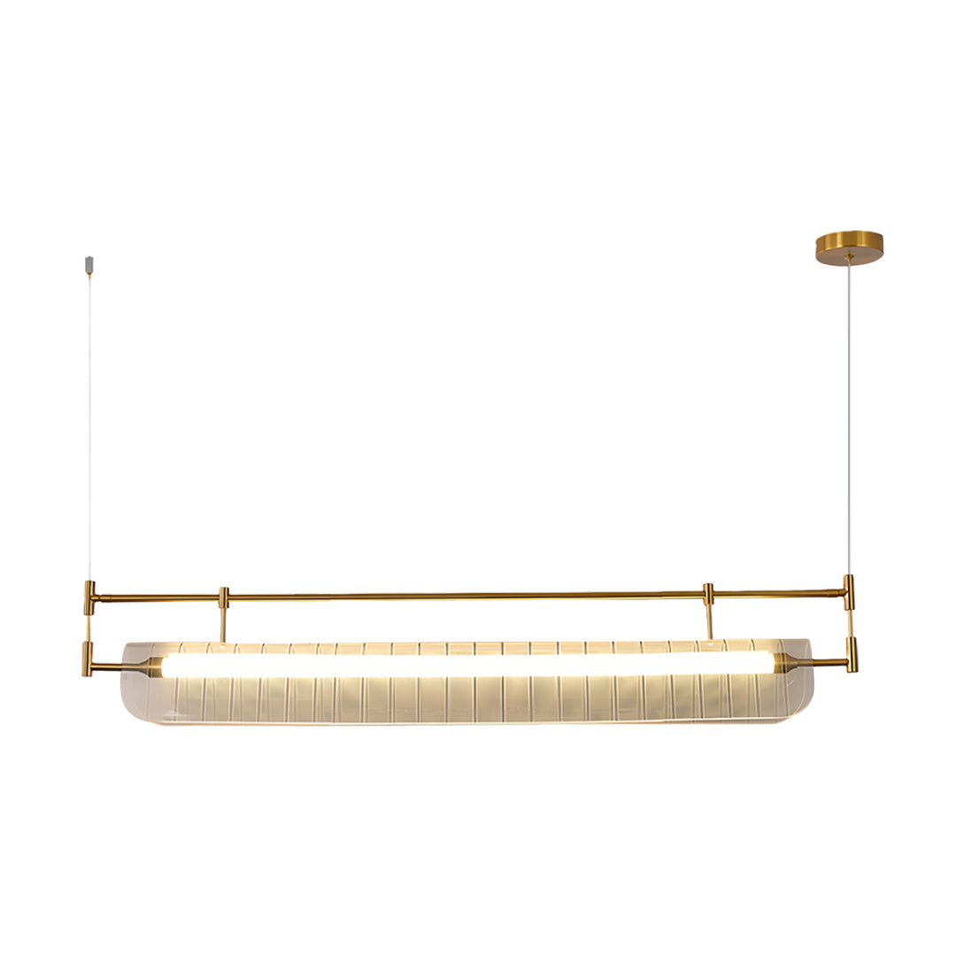 Linear light pendant in warm gold finish featuring elongated pleated glass shade with minimalist mounting.