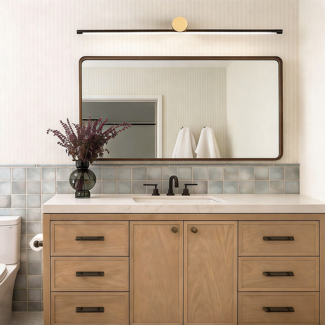 Linear vanity light bar mounted above mirror in a modern wood vanity bathroom
