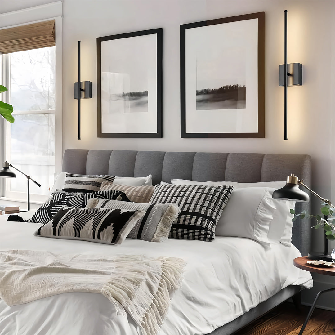 Linear wall lights flanking a bed, creating a symmetrical and contemporary lighting design in a bedroom.