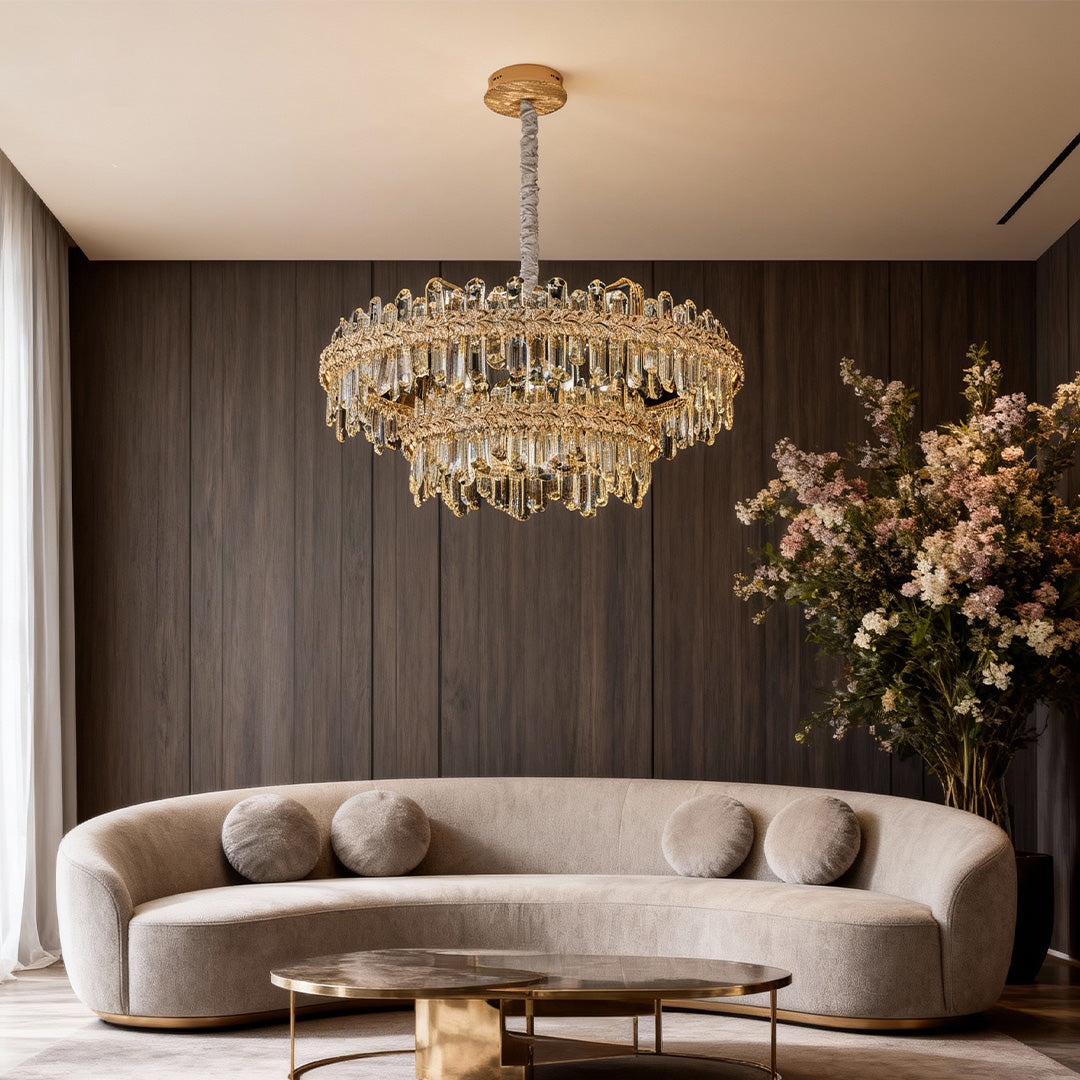 Gold chandelier lamps crystal hanging above a sofa in a modern living room.