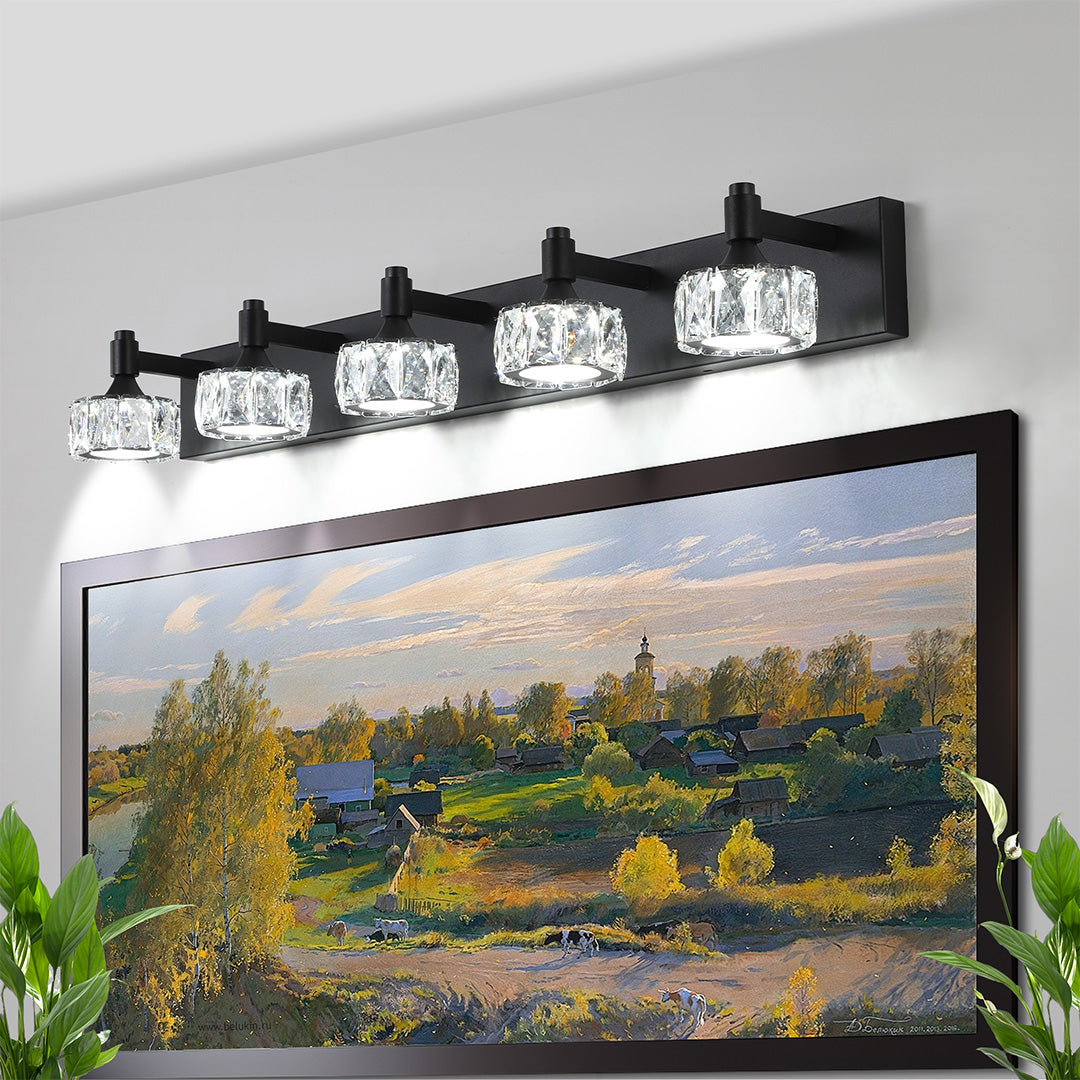 Luxurious crystal bathroom vanity light featuring glass shade chandelier styling above large landscape mirror with scenic reflection.