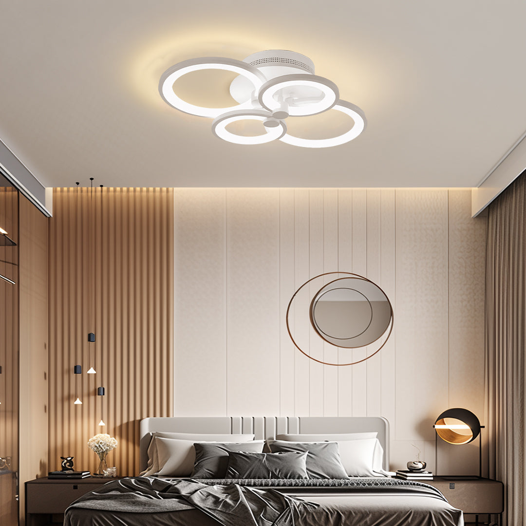 Luxury bedroom design enhanced by decorative multi ring ceiling lights with soft halo lighting.