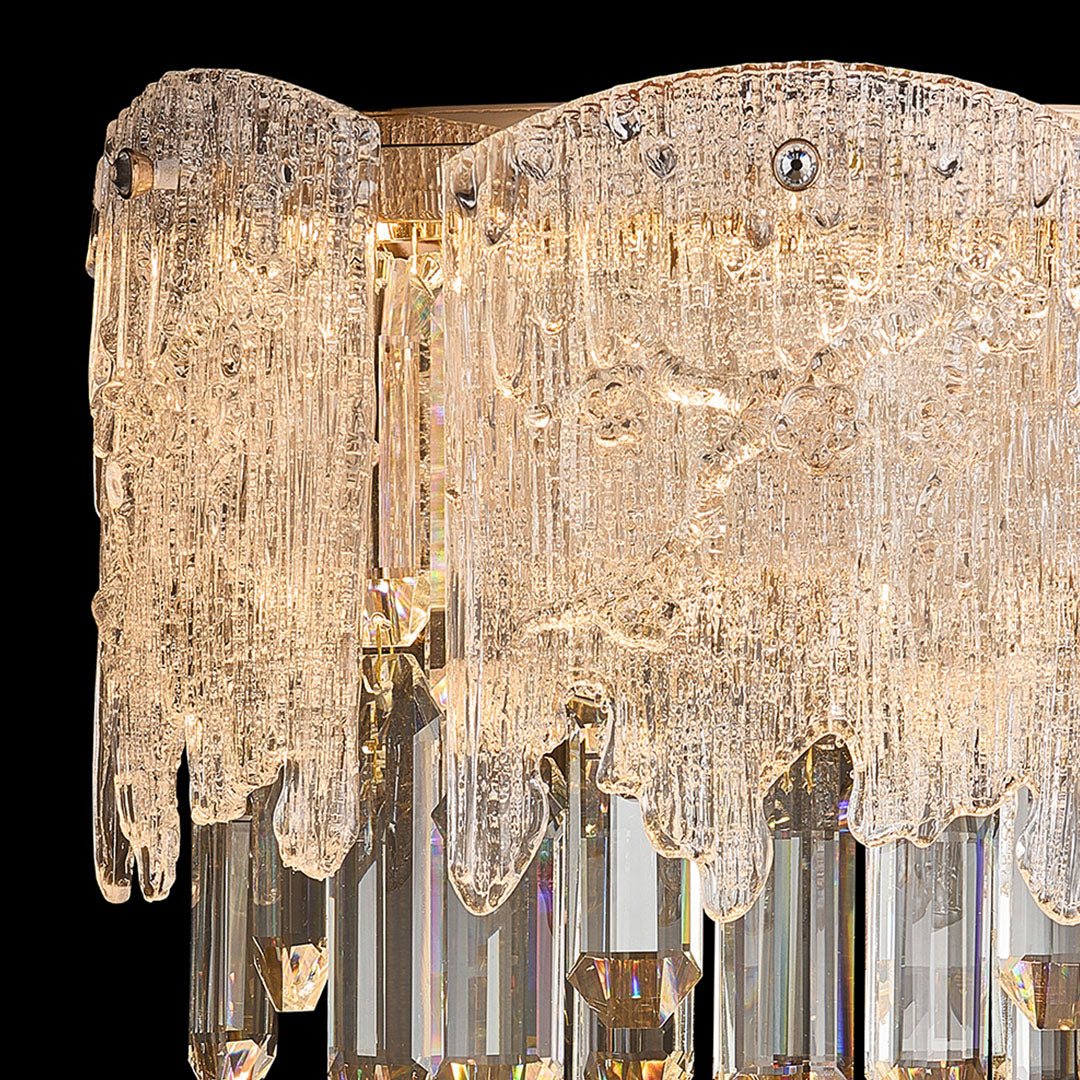 Detailed view of gold frame and layered crystals on luxury crystal wall sconce lighting.