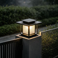 Luxury villa entrance illuminated by driveway pillar solar lights mounted on tall gate columns.