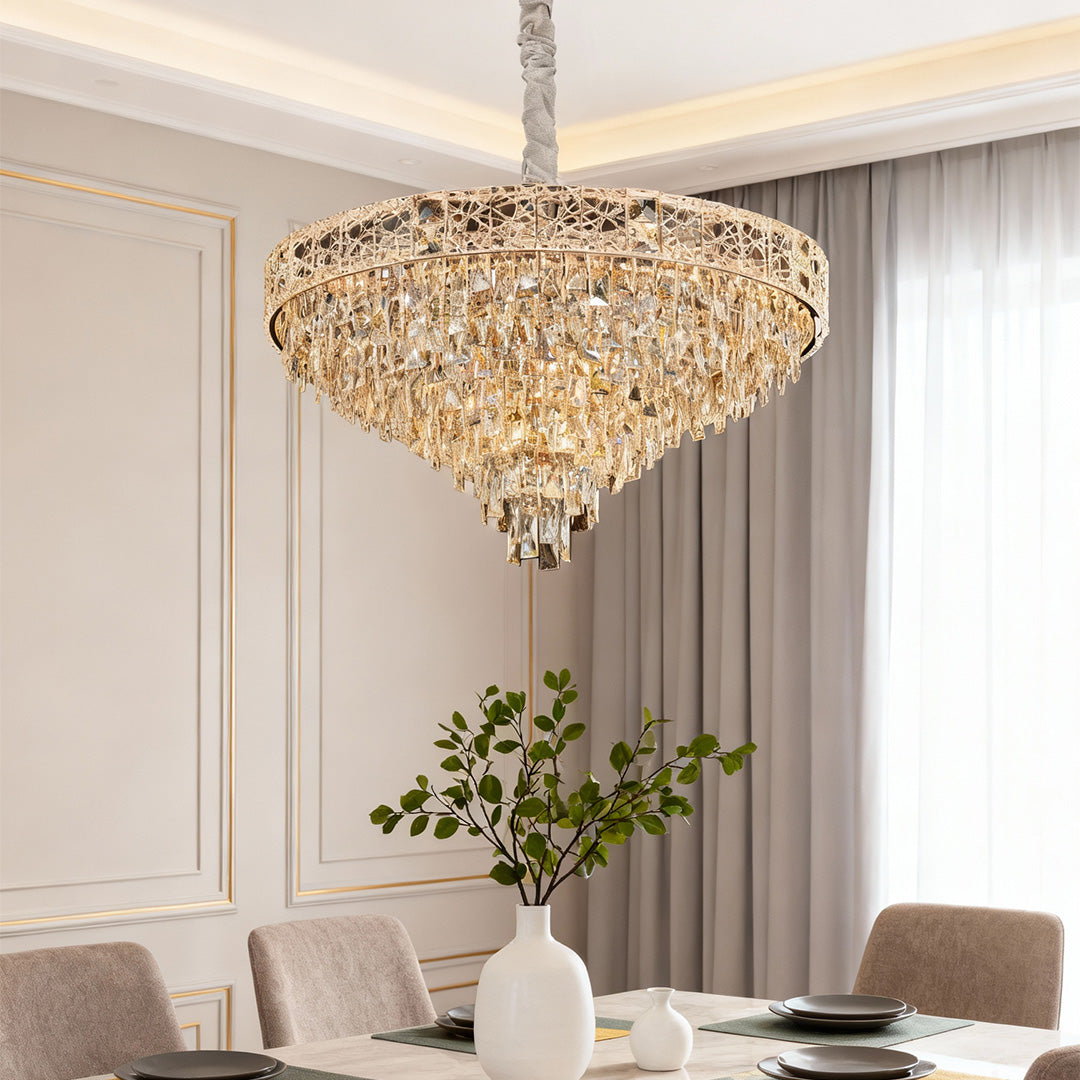 Luxury gold large chandelier crystals with faceted teardrops above elegant dining table.