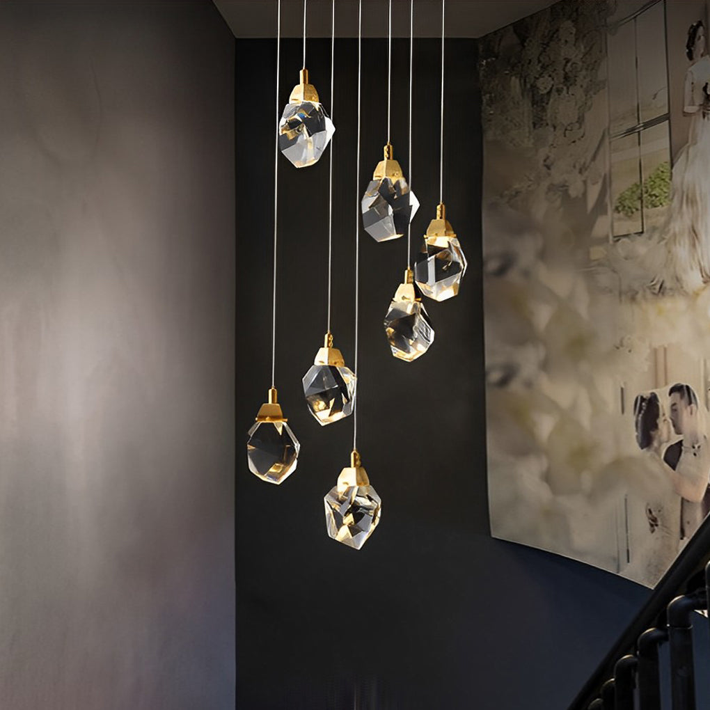 Luxury staircase chandelier with gold-finished crystal droplets, enhancing a sophisticated hallway.