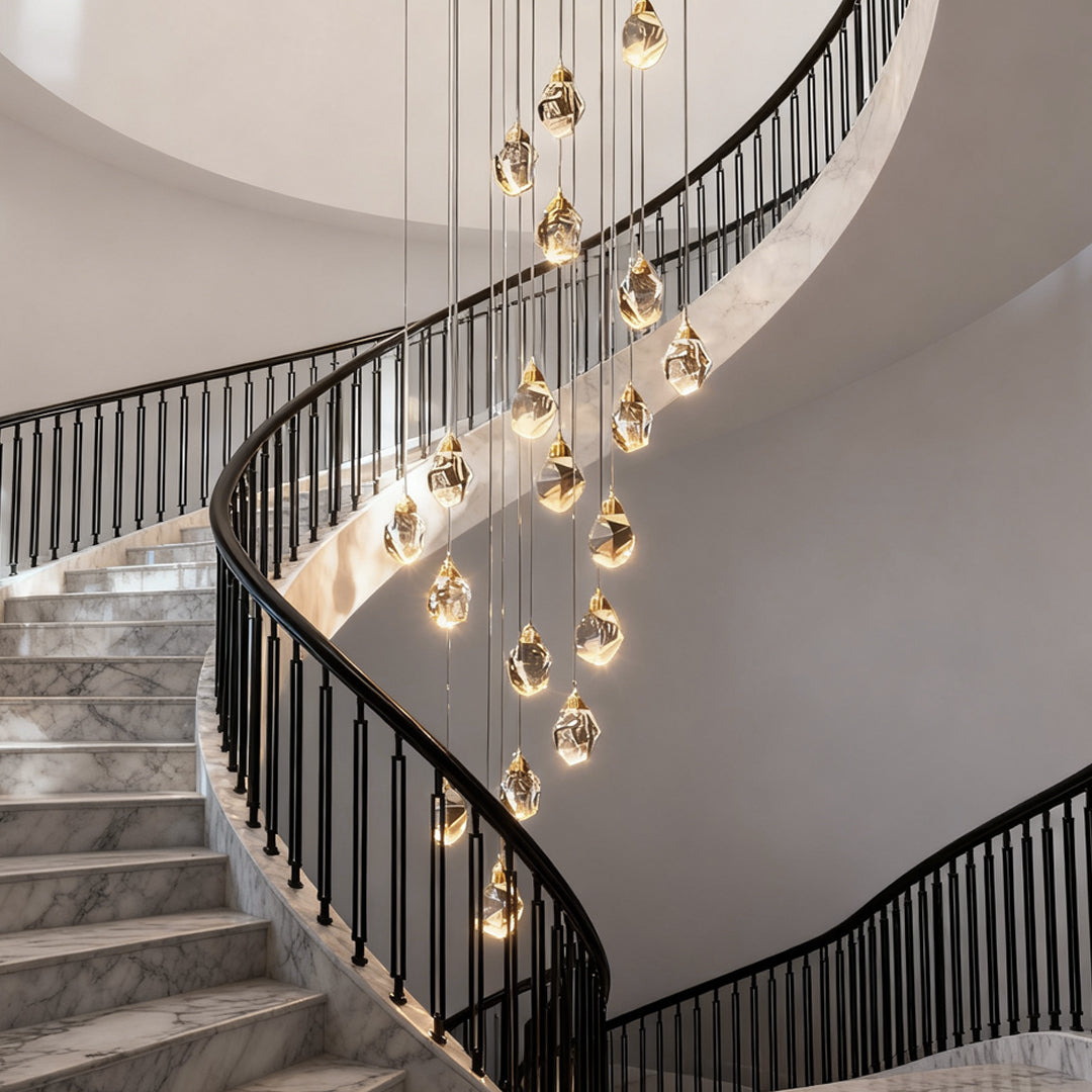 Luxury staircase chandelier in a spacious foyer, showcasing its intricate crystal and gold design.