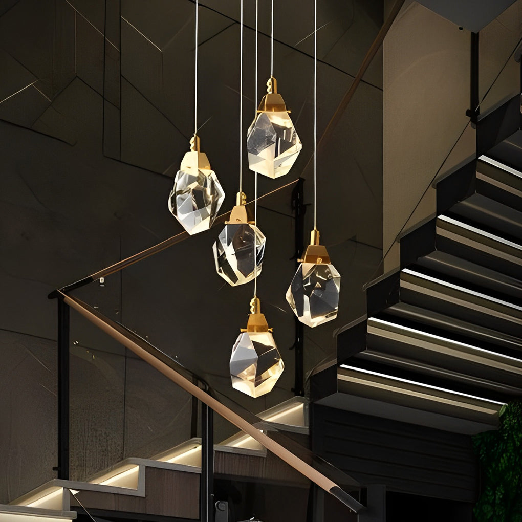 Luxury staircase chandelier hanging above a wooden staircase, blending modern and classic styles.