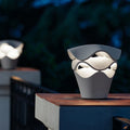 Modern macro shot of wave design path light on a stone pillar with warm glowing LED lighting.