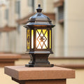 Matching outside pillar lights pair installed on wooden posts creating traditional outdoor lighting for garden pathways