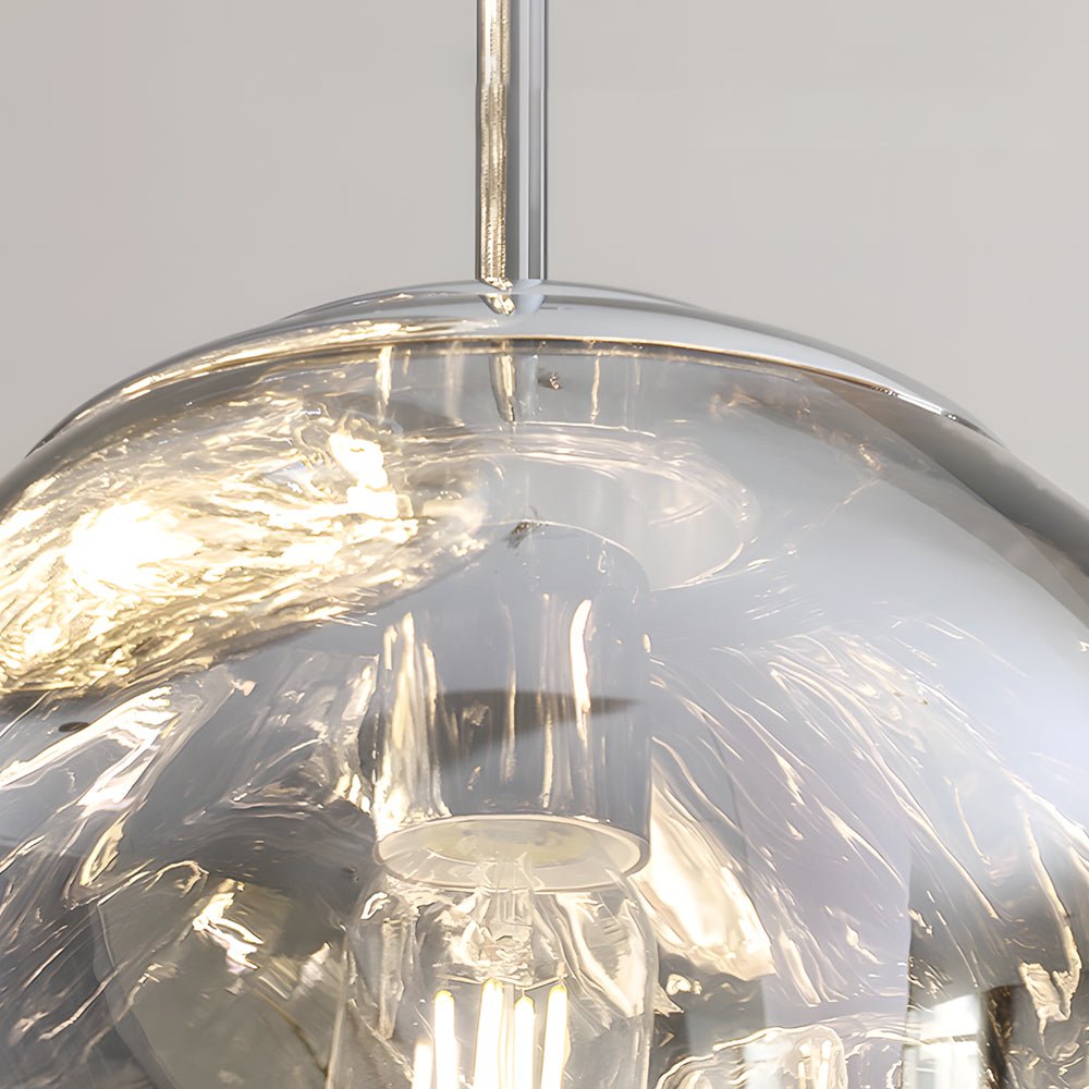 Close-up detail of melt LED pendant light glass shade, showing reflective texture and internal LED structure.