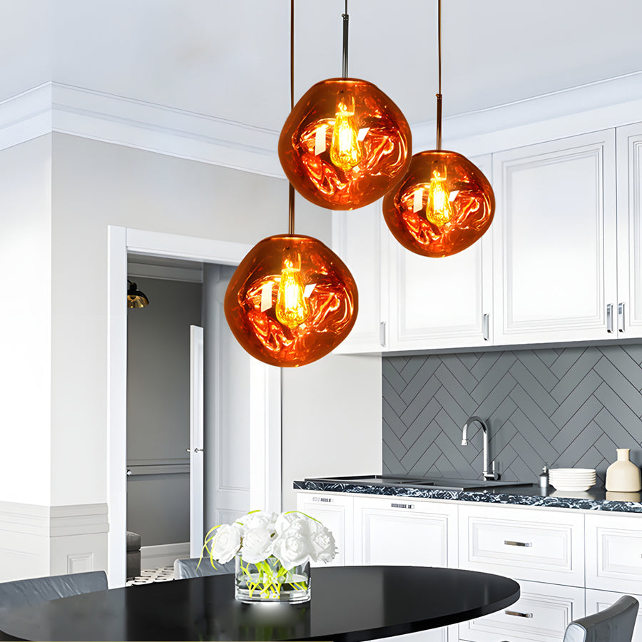 Multiple melt pendant lights hanging above a kitchen counter