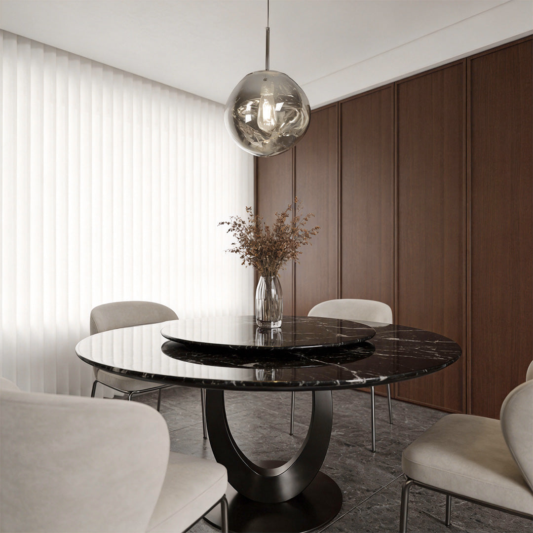 Melt pendant light installed above a round dining table