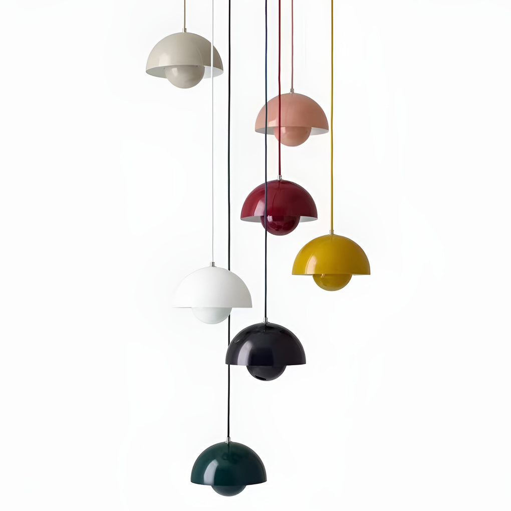Metal dome pendant light in assorted colors, hanging at varying heights in modern interior.
