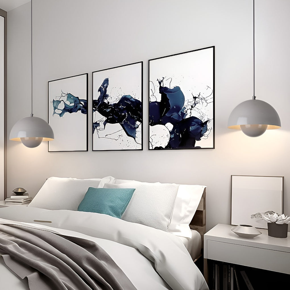Metal dome pendant light in blue, hanging above modern bedside tables and artwork.