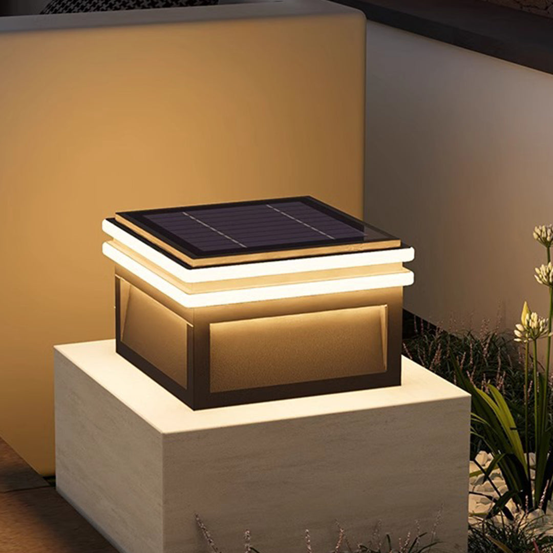 Metal pillar lights near a patio, providing elegant illumination for evening gatherings.