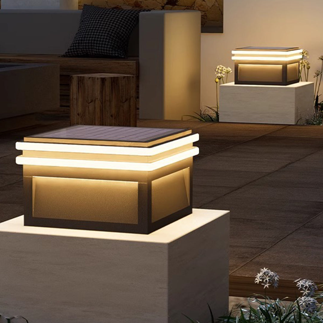 Metal pillar lights with a solar panel, offering eco-friendly and stylish outdoor lighting.