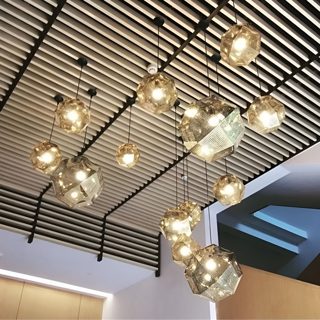 Multiple metal shade pendant light fixtures suspended from a ceiling, forming a dramatic geometric lighting installation.
