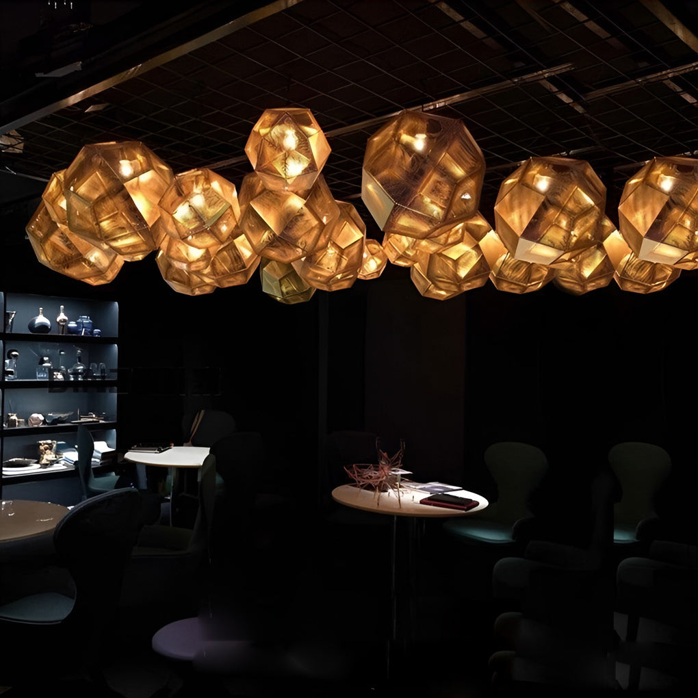 Row of metal shade pendant light fixtures hanging above a dining area, creating soft ambient illumination.