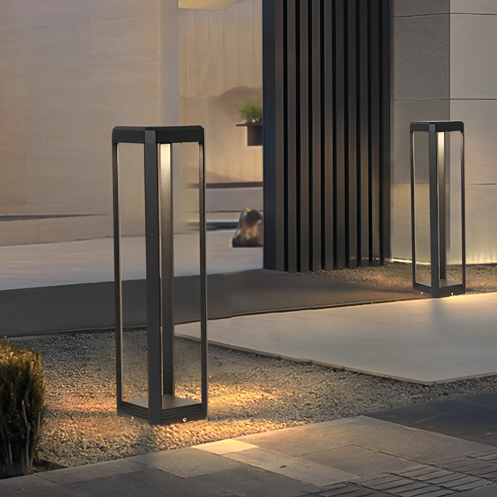 Metal solar pathway lights near a building entrance, offering contemporary and sustainable lighting.