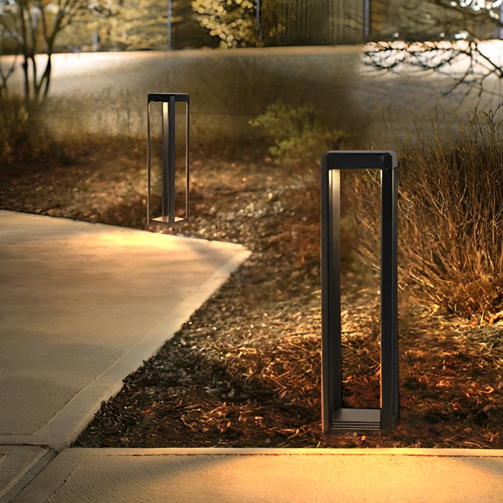 Metal solar pathway lights in a garden, casting a gentle glow on the surrounding plants.