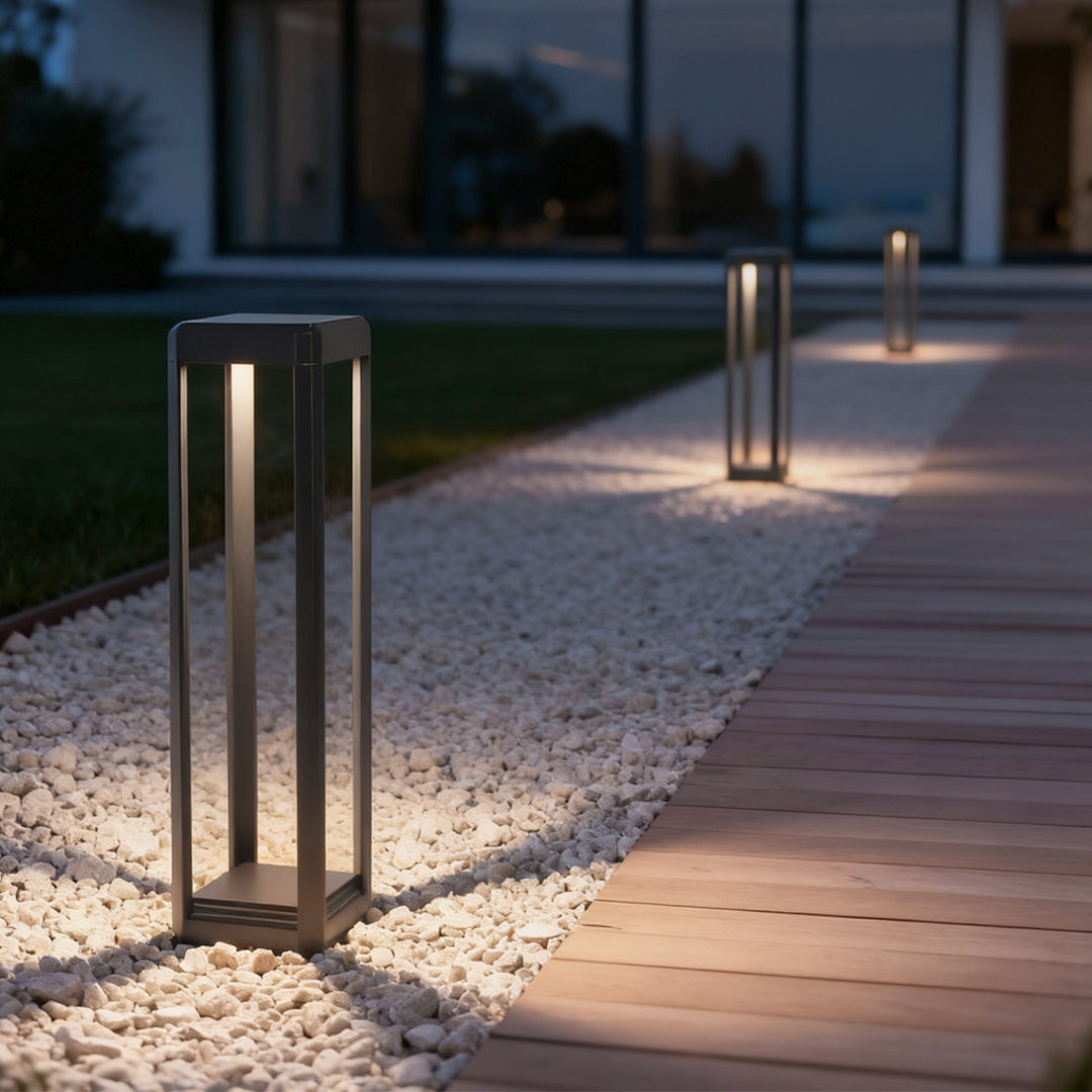 Metal solar pathway lights lining a gravel pathway, creating a warm and inviting outdoor ambiance.