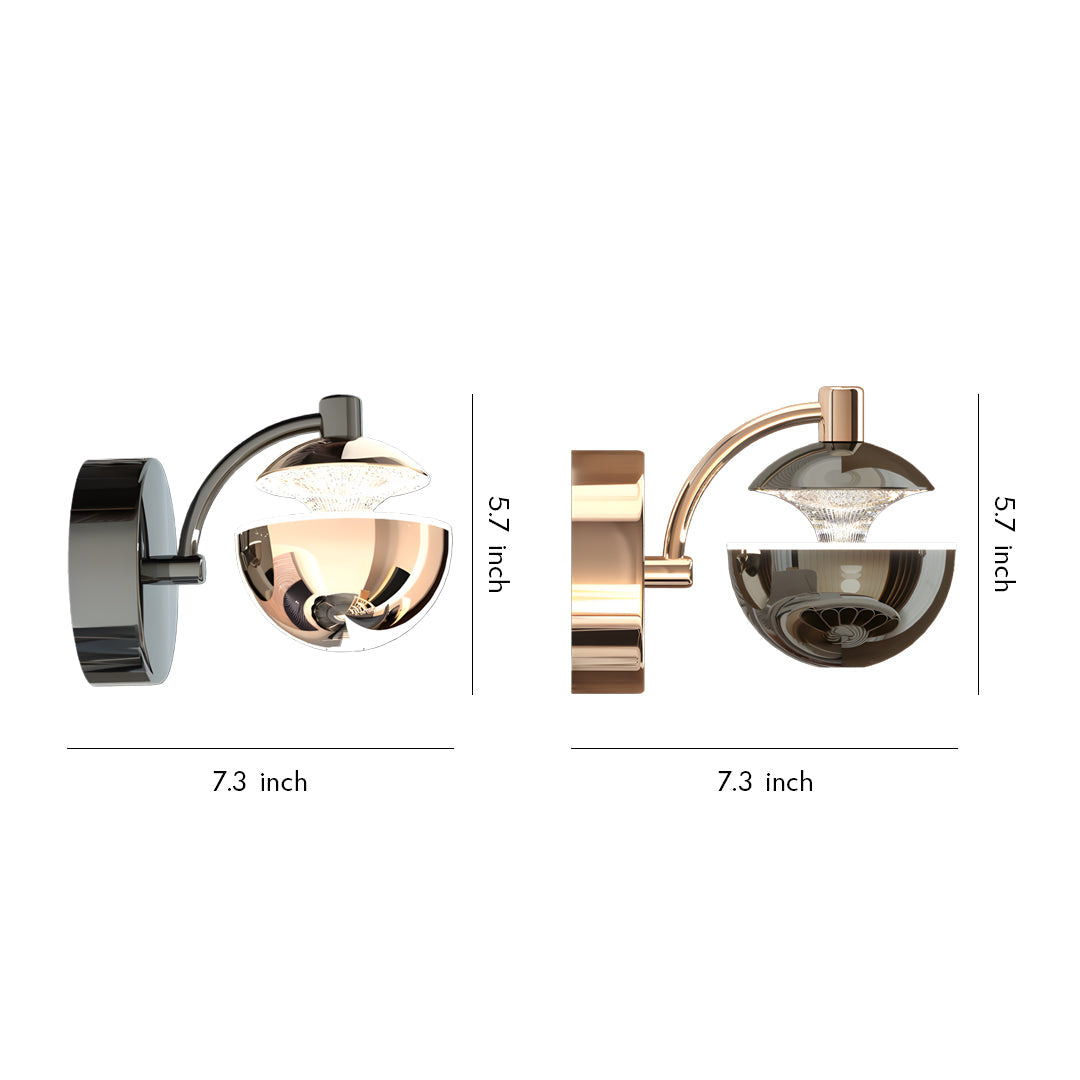 Metal wall sconce featuring two spherical glass shades with adjustable articulating arms in mixed black and gold finish