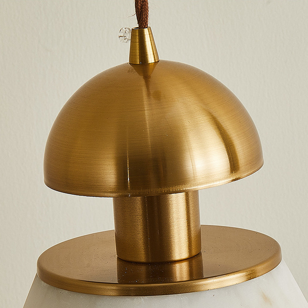 Close-up detail of metallic pendant lights showing brushed brass finish and tiered shade construction design
