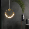 Mini crystal ring pendant light with a sleek design, providing ambient lighting in a contemporary room.