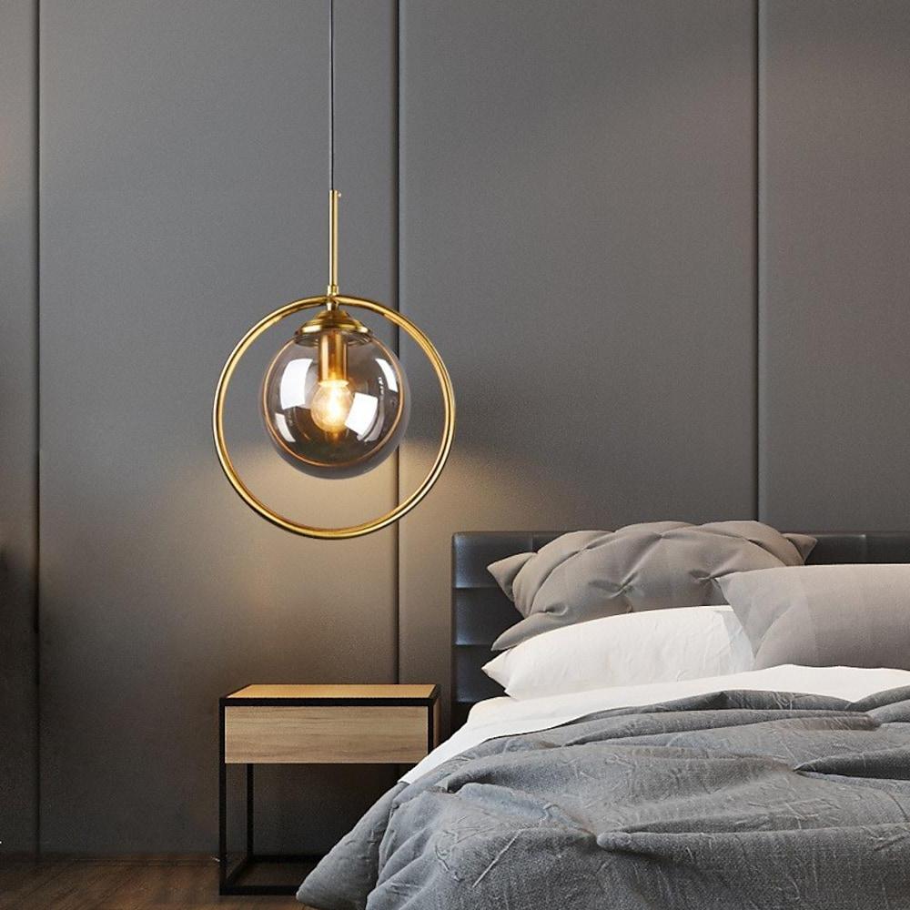 Mini gold pendant light enhancing a stylish bedroom with sleek, minimalist design.