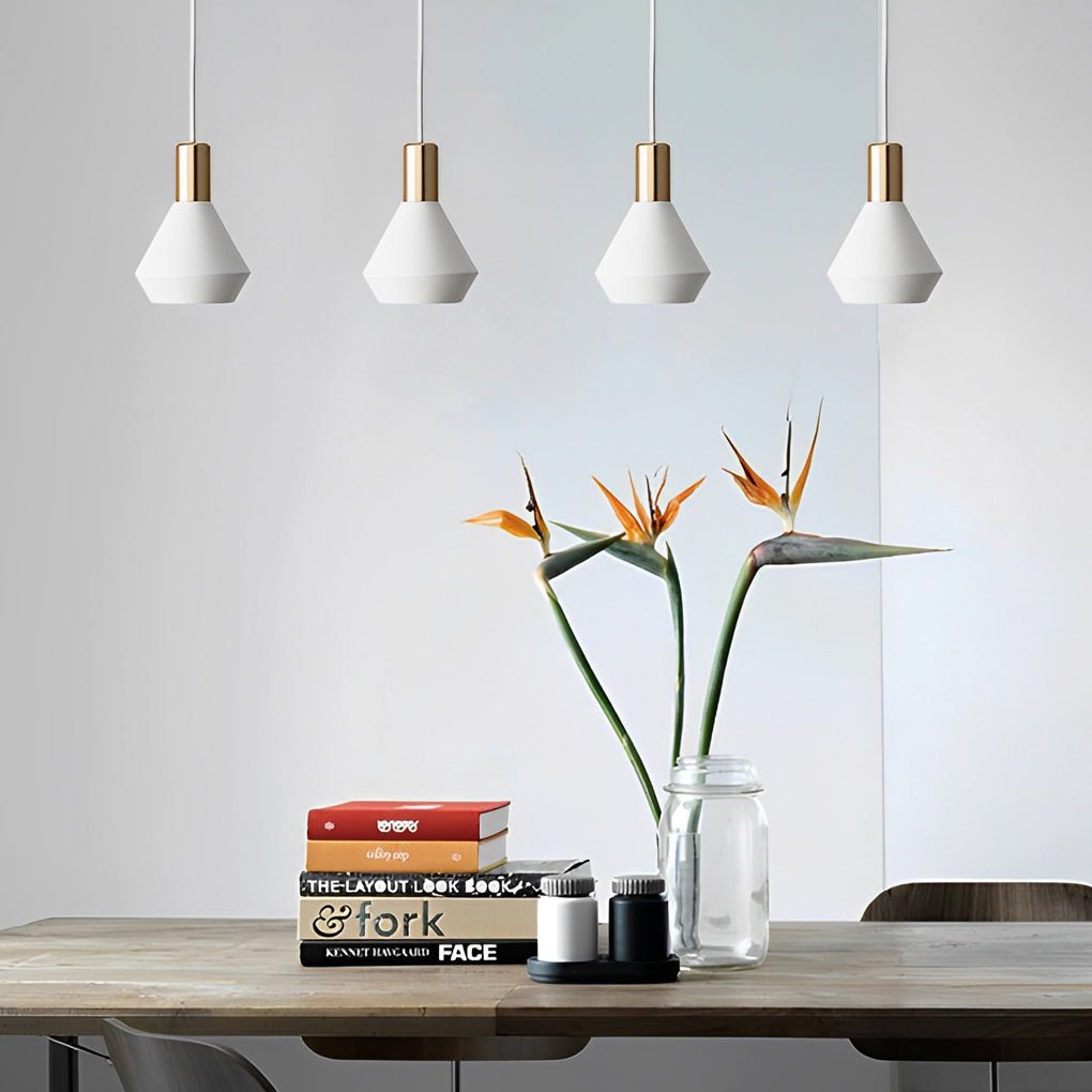 Mini hanging pendant lights arranged in a row above a wooden table, offering clean minimalist lighting for a modern dining area.