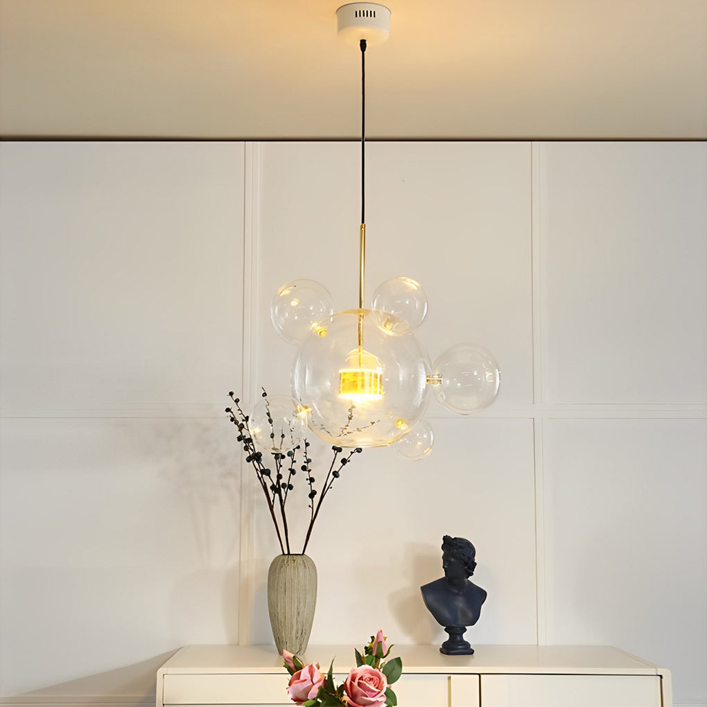 Clear bubble chandelier with minimalist design against white wall background.