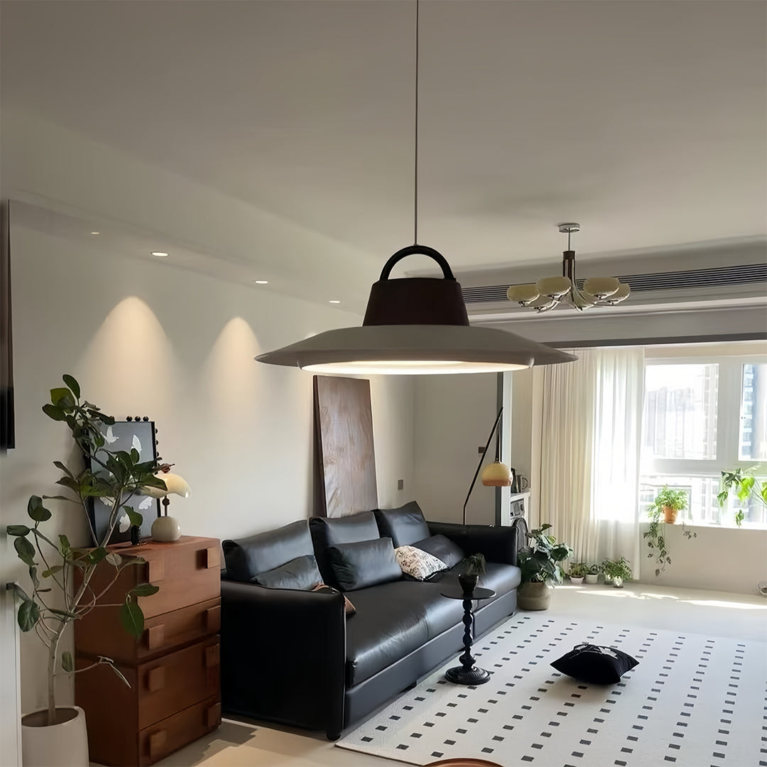 Minimalist single pendant lights for kitchen providing task lighting over contemporary dining setup