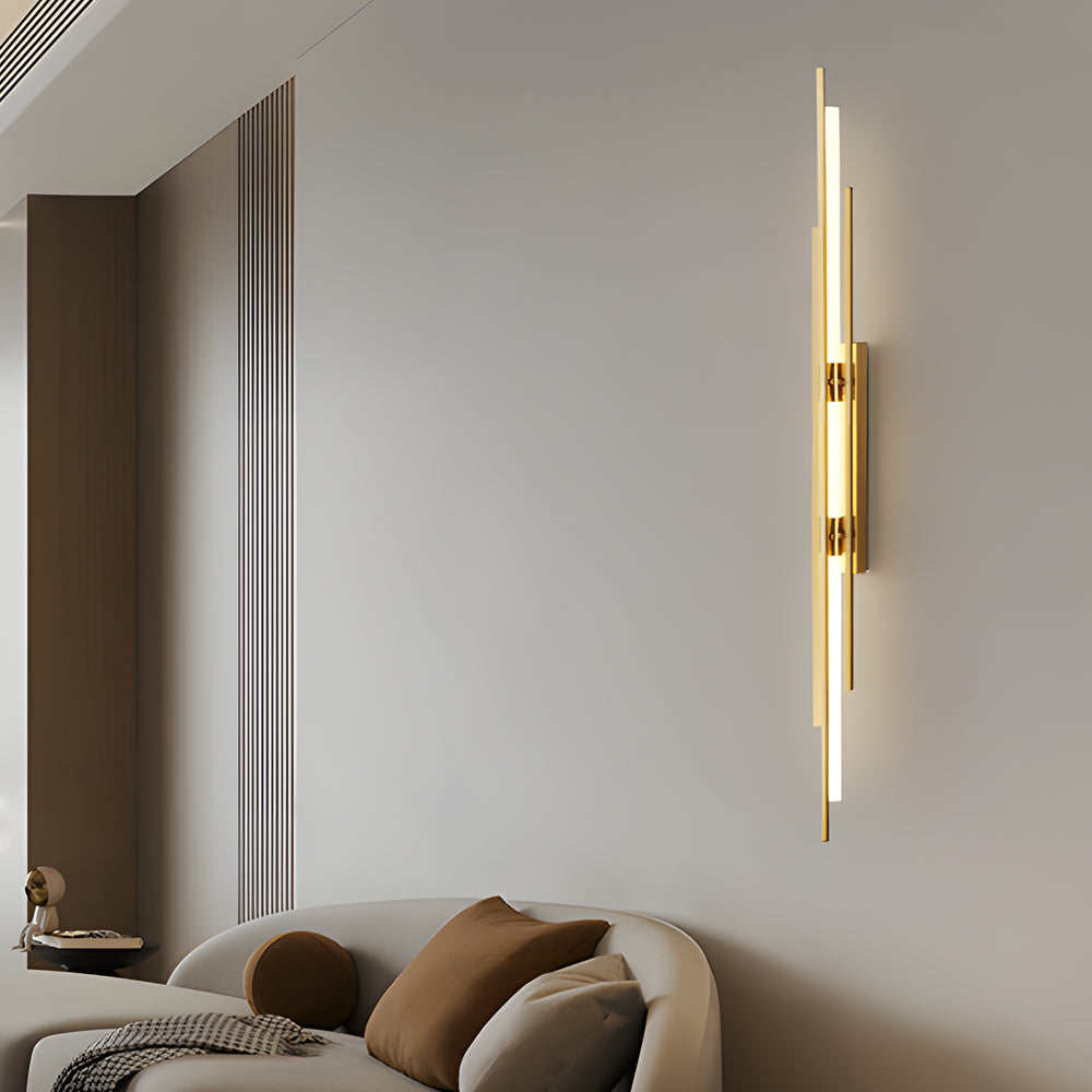 Minimalist vertical tube wall sconce mounted on light gray bedroom wall.