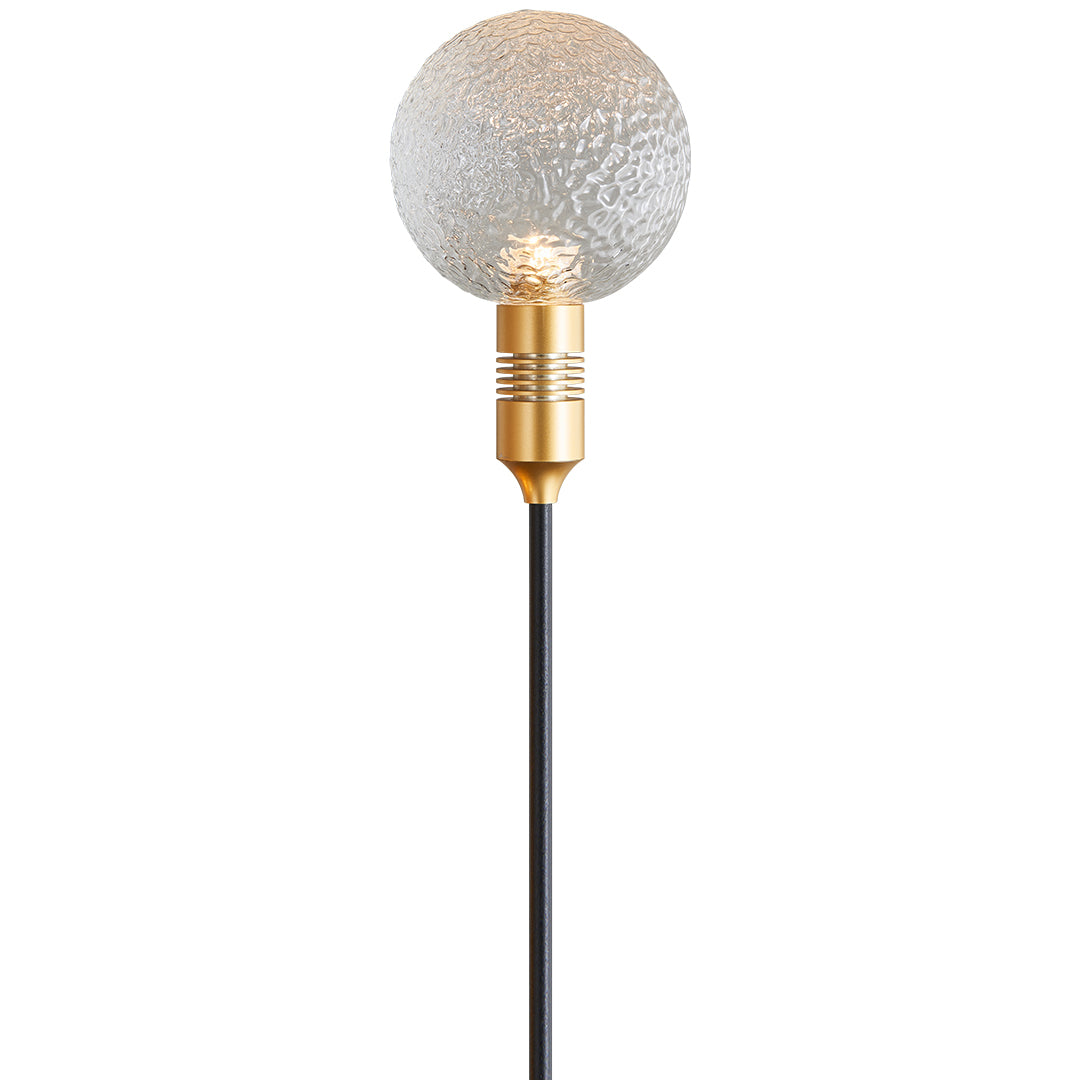 Tall trio of mixed-color crackle globe stake lights illuminating a modern yard with path landscape lighting.