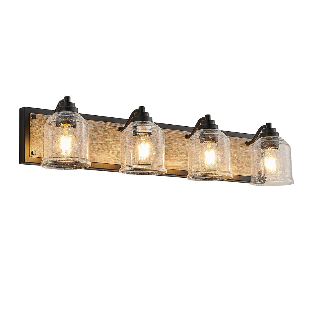 Multi-light wall sconce with clear glass shades, mounted above a round mirror in a modern bathroom.