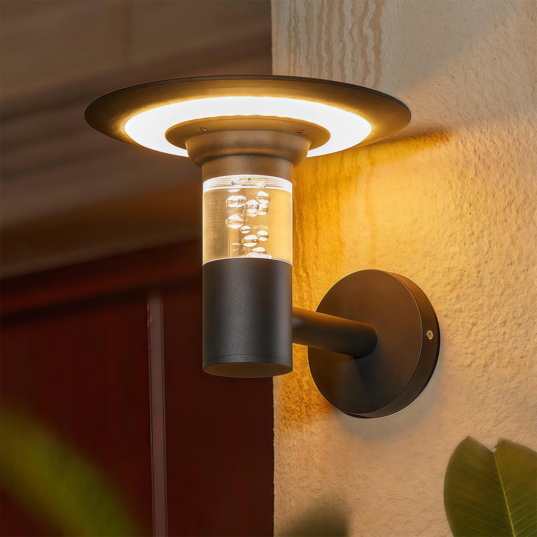 Modern black solar outdoor wall lighting fixture with a bubble glass cylinder and a wide 'halo' shade.