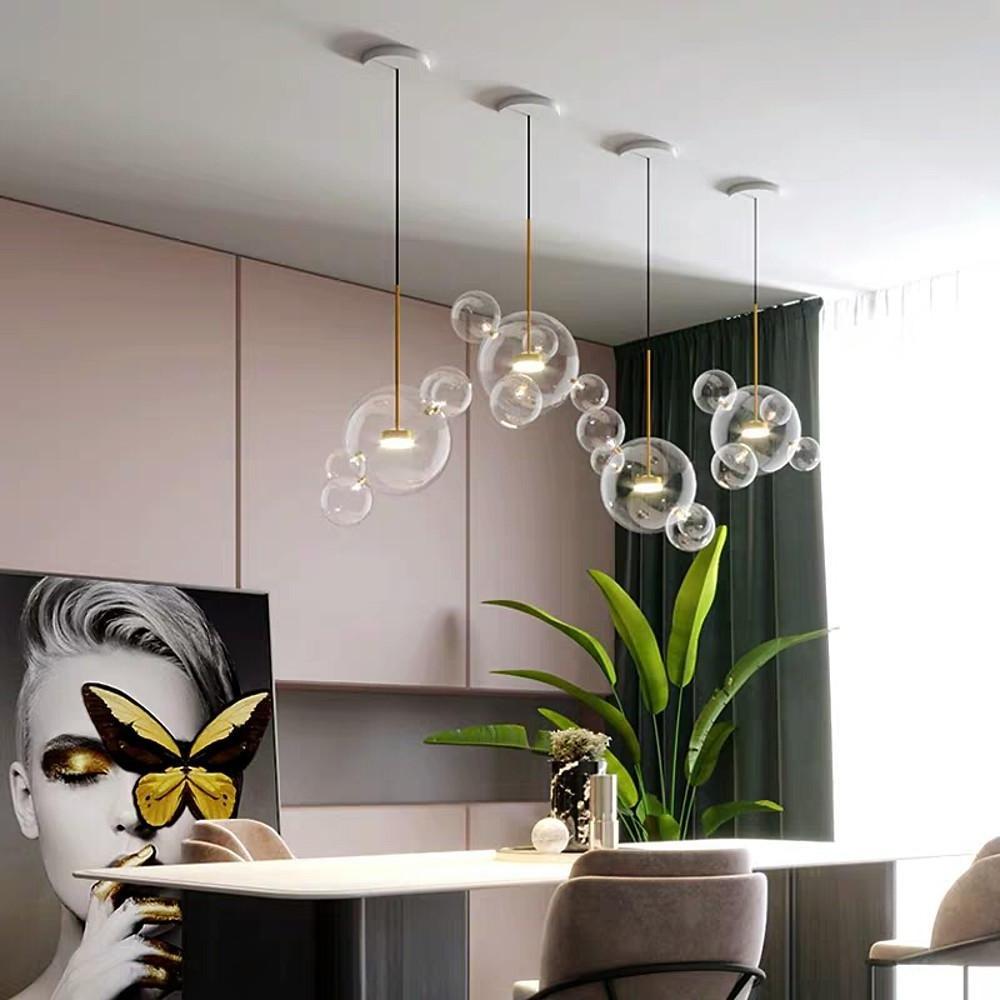 Modern clear bubble chandelier with clustered glass spheres in living space.