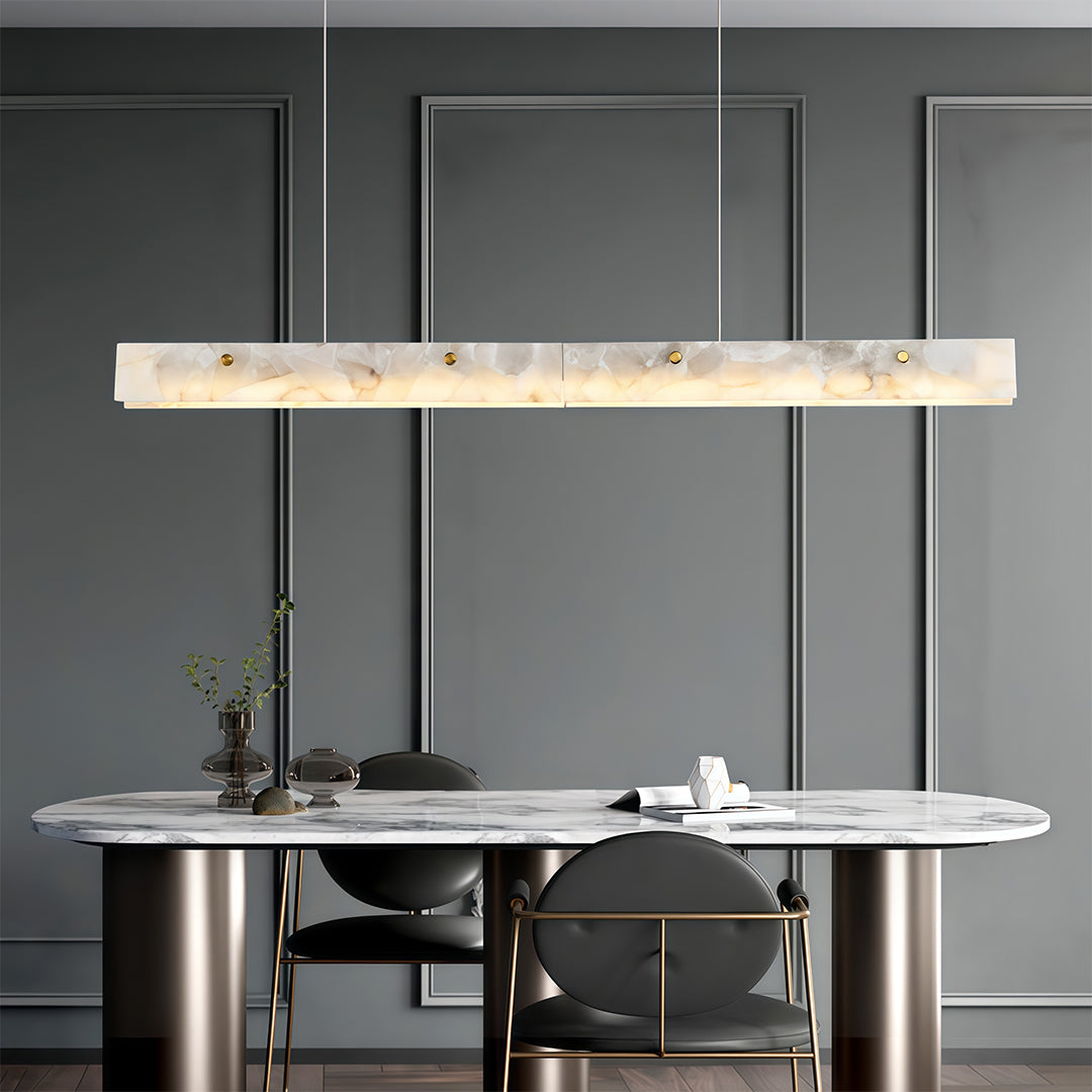 Modern copper metal pendant light with a marble accent, providing stylish illumination in a minimalist kitchen.