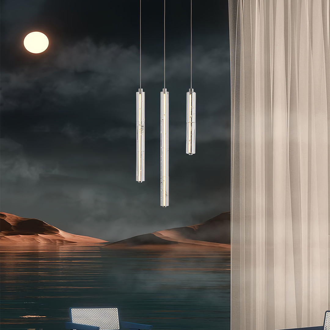Modern crystal pendant light with a cylindrical crystal design, adding a touch of luxury to a bedroom.