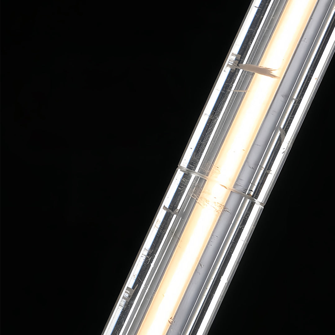 Modern crystal pendant light with a sleek cylindrical shape, hanging in a contemporary living space.