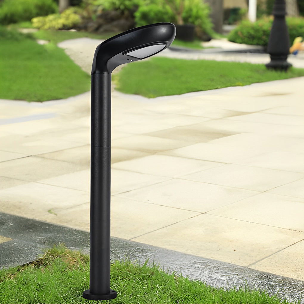 Modern curved bollard light standing on a paved outdoor path.