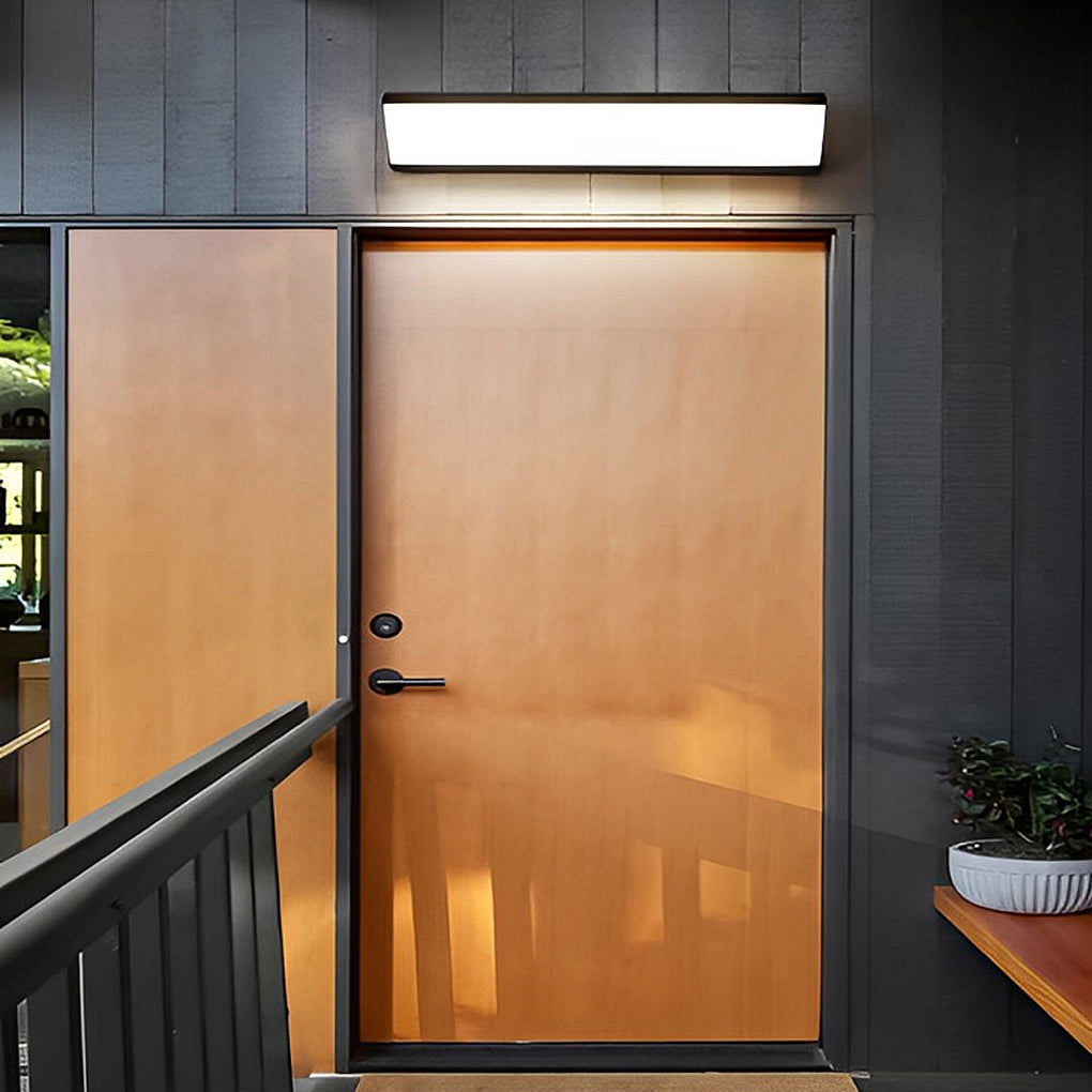 Modern exterior wall light fixture mounted above a front door for entryway illumination.