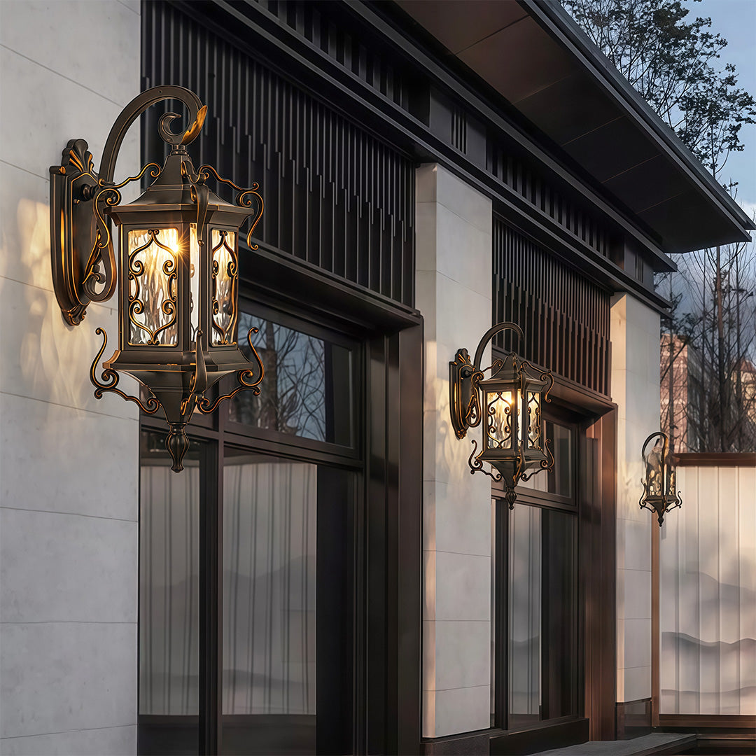 Row of outdoor wall sconce lights brightening exterior facade of modern building.