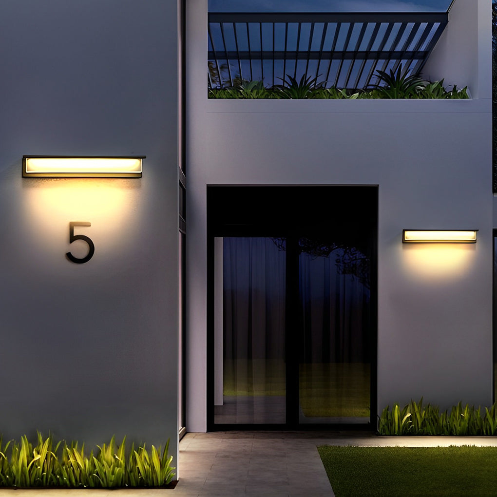 Front porch light fixtures with modern design on gray wall.