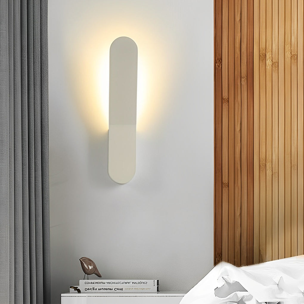 Modern glass pendant chandelier casting a gentle glow near a green indoor plant.