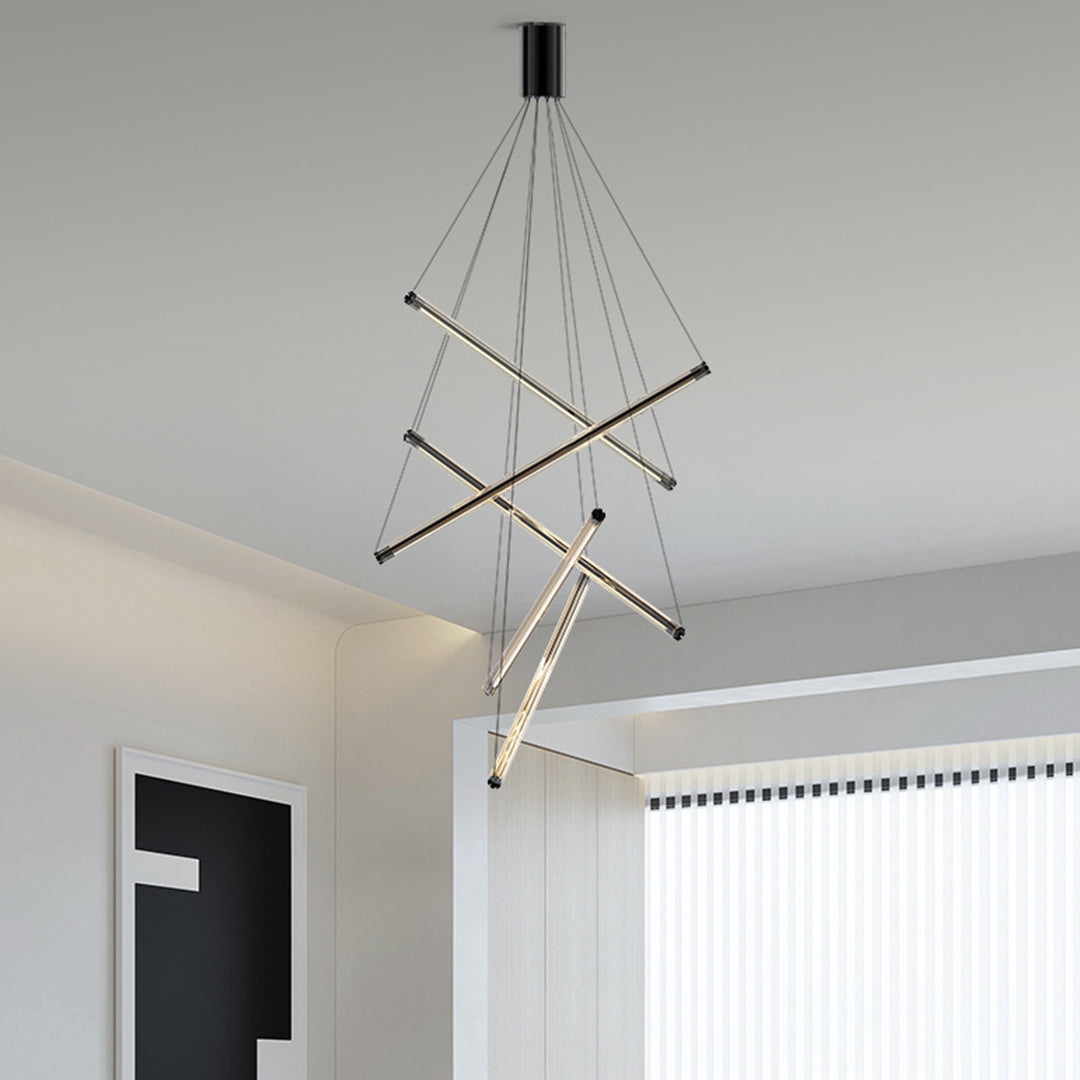 Modern LED linear chandelier with gold bars and thin cables, illuminating a hallway with neutral tones and wooden accents.