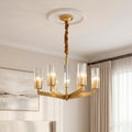 Elegant modern gold candle chandeliers featuring angular arms and ribbed glass shades in a sophisticated room.