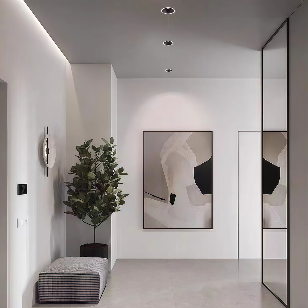 Modern white hallway using LED downlight recessed fixtures to provide bright, focused illumination on artwork.